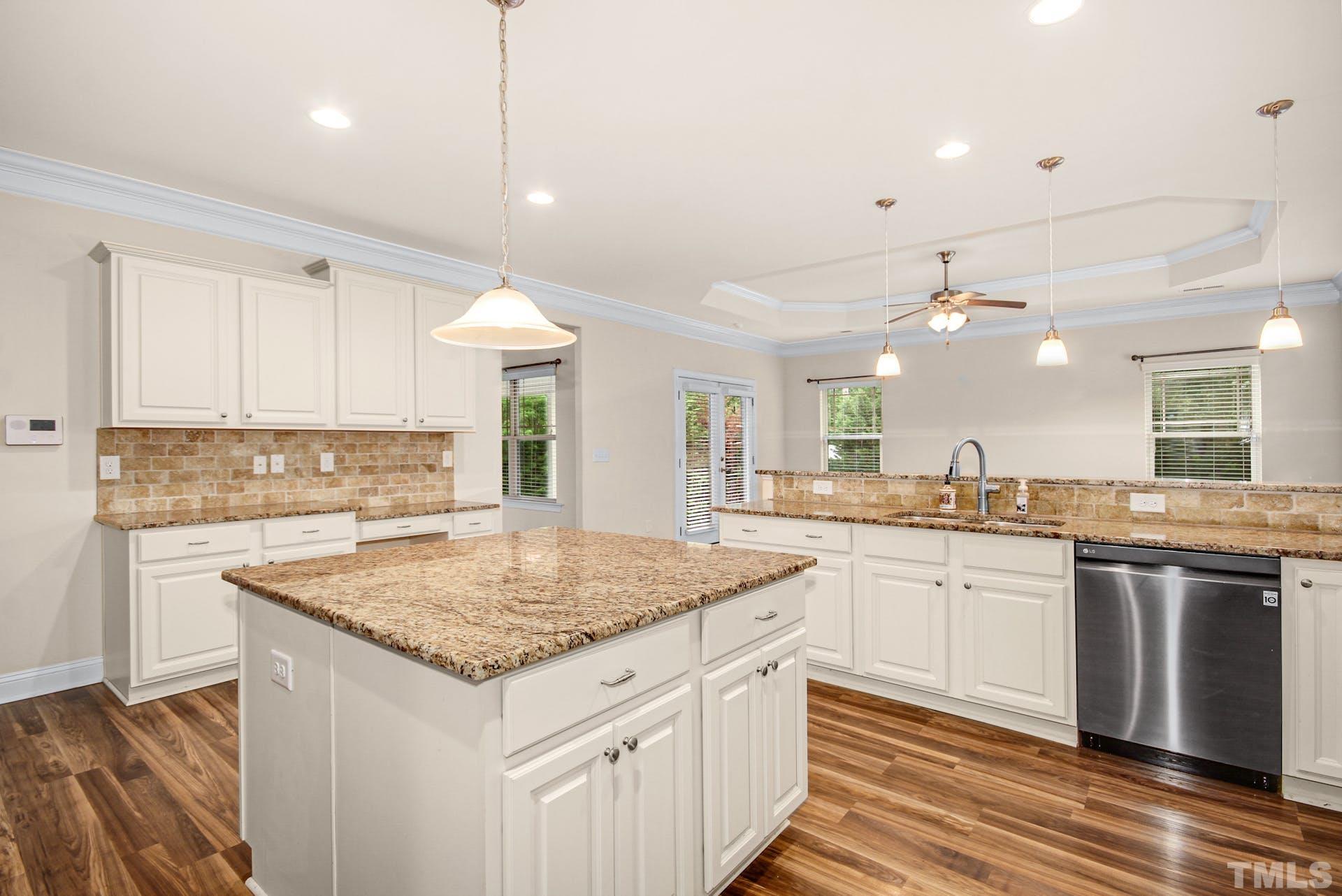 44 Destiny Circle Angier, NC 27501 - Photo 18 of 35 a kitchen with stainless steel appliances granite countertop stove top oven and cabinets