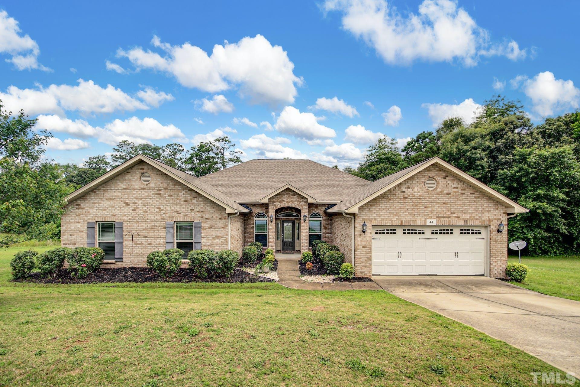 44 Destiny Circle Angier, NC 27501 - Photo 2 of 35 a front view of a house with a yard and garage
