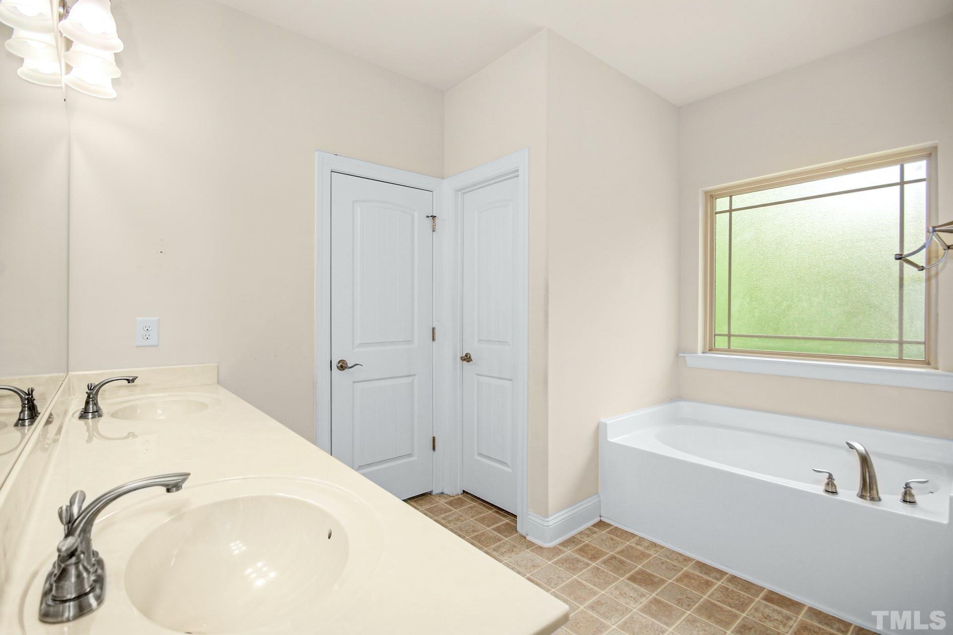 44 Destiny Circle Angier, NC 27501 - Photo 21 of 35 a bathroom with a tub and a sink