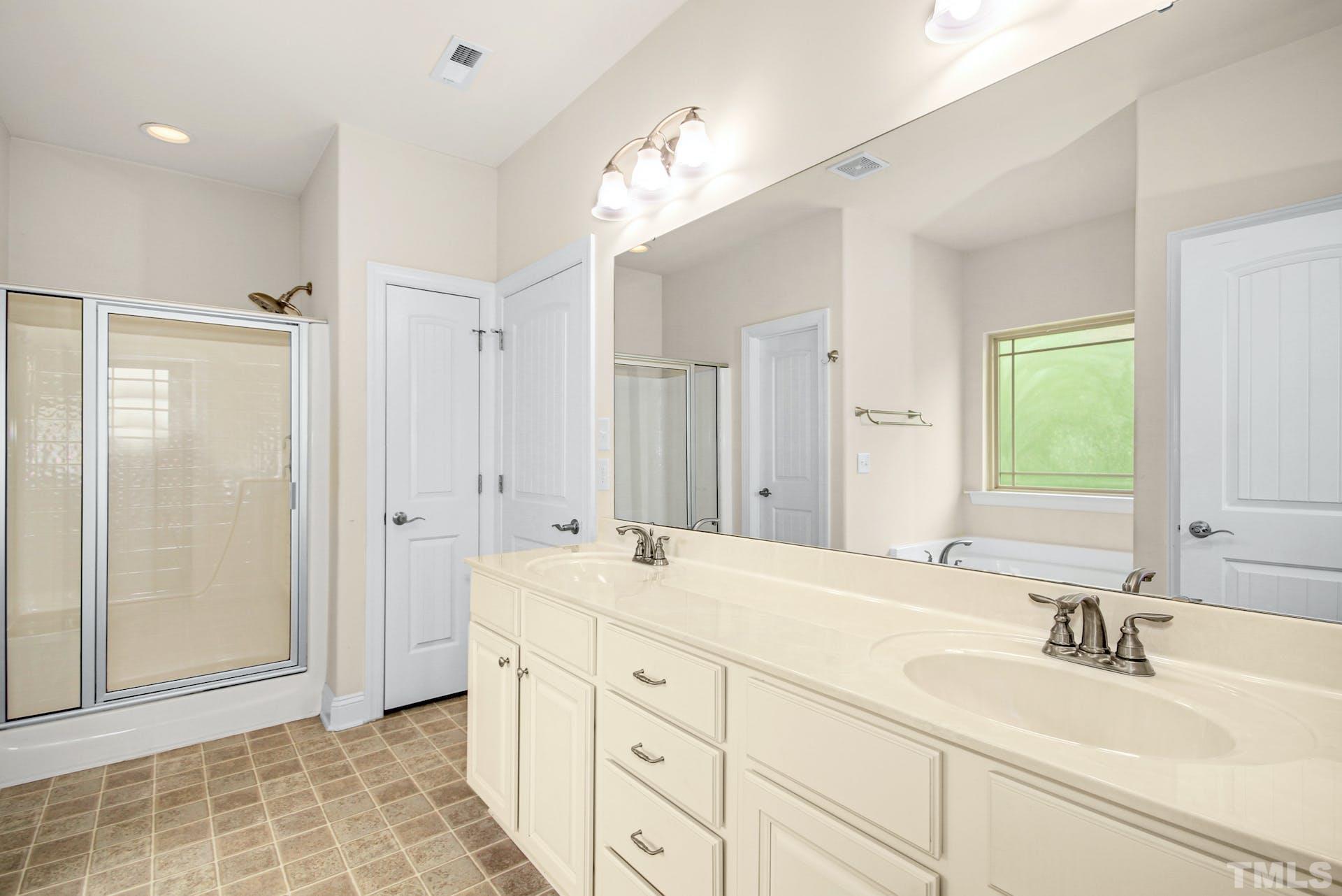 44 Destiny Circle Angier, NC 27501 - Photo 22 of 35 a spacious bathroom with a double vanity sink mirror and shower