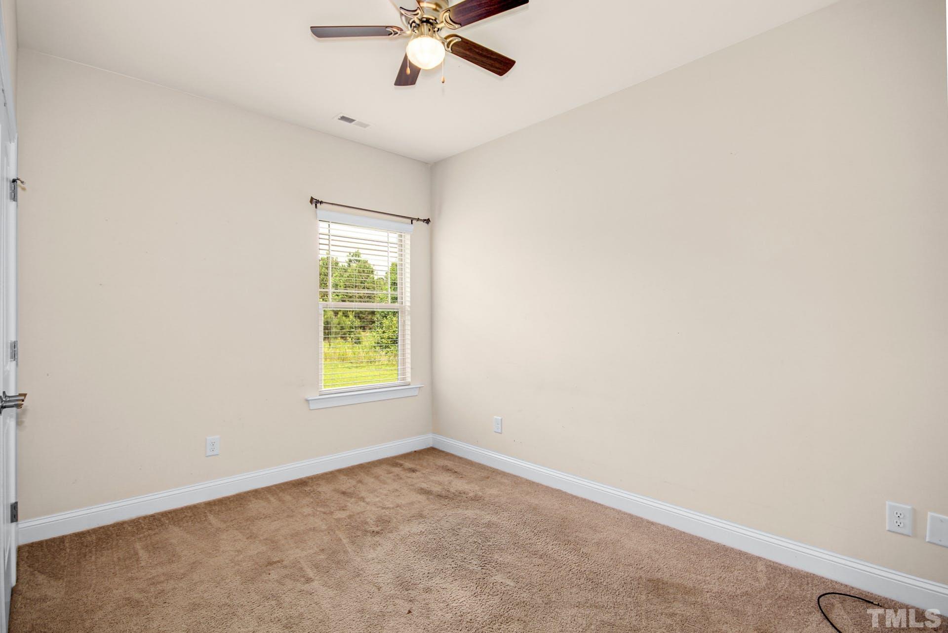 44 Destiny Circle Angier, NC 27501 - Photo 25 of 35 an empty room with a window and a fan
