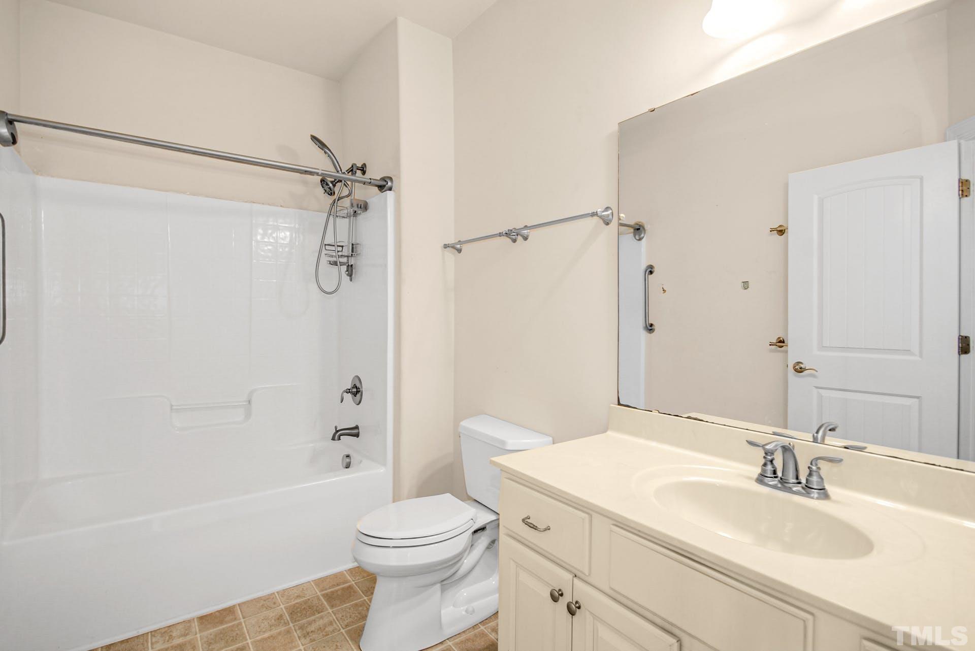 44 Destiny Circle Angier, NC 27501 - Photo 26 of 35 a bathroom with a granite countertop sink toilet and shower