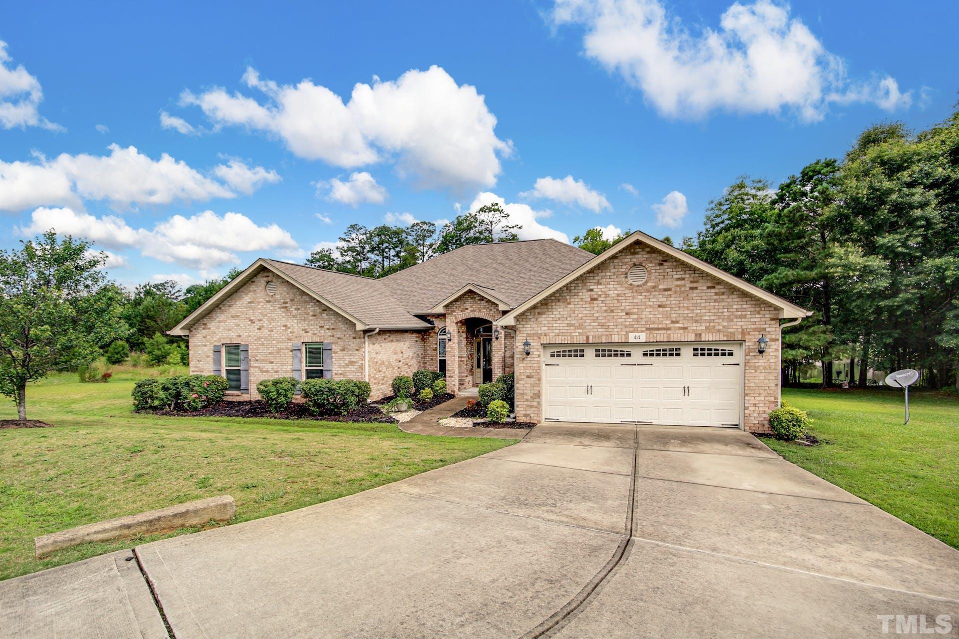 44 Destiny Circle Angier, NC 27501 - Photo 3 of 35 a view of a white house with a big yard and large trees