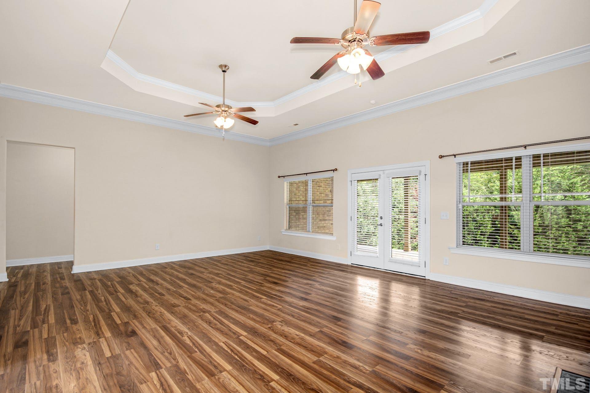 44 Destiny Circle Angier, NC 27501 - Photo 10 of 35 a view of an empty room with wooden floor and a window