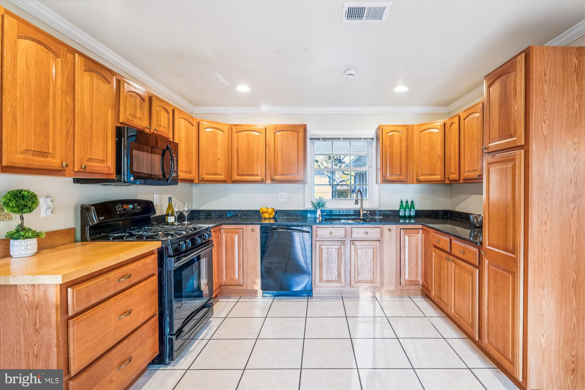 5134 West Running Brook Road Columbia, MD 21044 - Photo 19 of 99 a kitchen with stainless steel appliances granite countertop wooden cabinets a stove top oven a sink and dishwasher