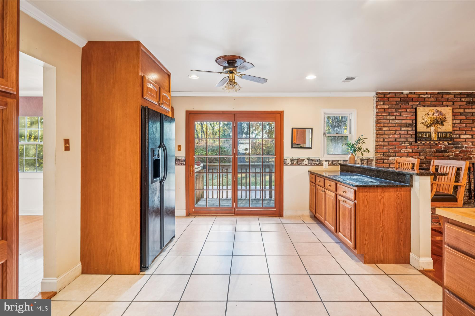 5134 West Running Brook Road Columbia, MD 21044 - Photo 23 of 99 a large kitchen with granite countertop a large window and a refrigerator