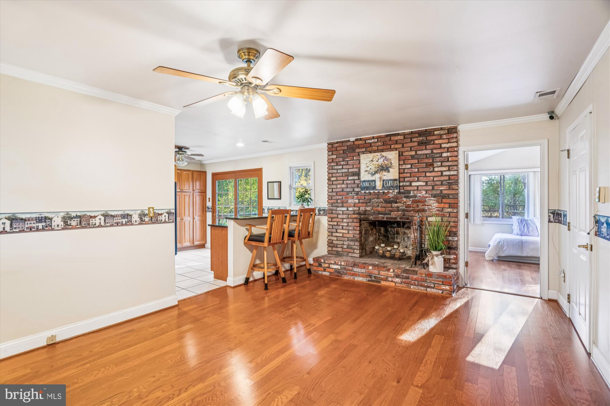 5134 West Running Brook Road Columbia, MD 21044 - Photo 33 of 99 a view of a livingroom with a fireplace a ceiling fan and wooden floor