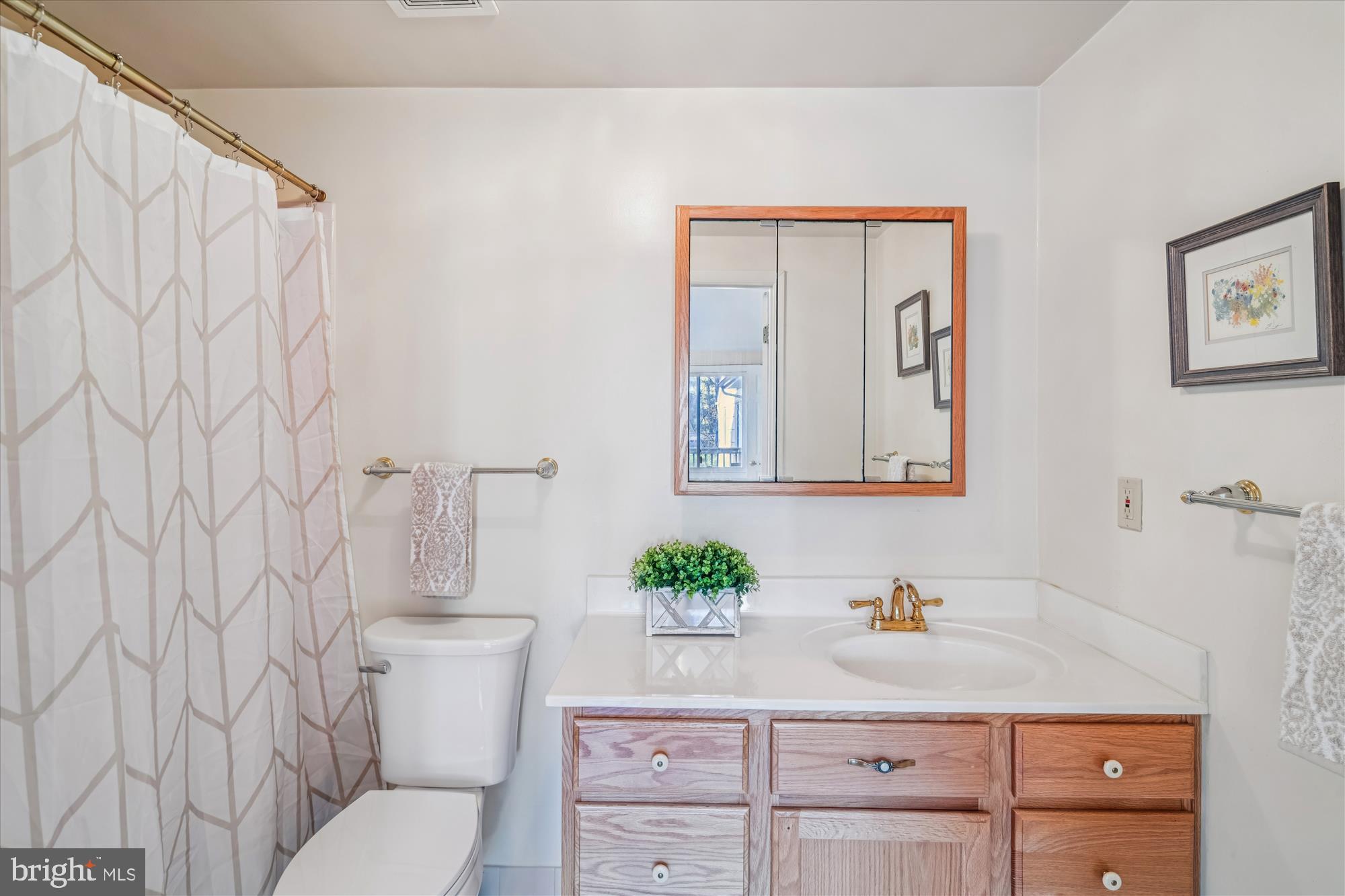 5134 West Running Brook Road Columbia, MD 21044 - Photo 40 of 99 a bathroom with a granite countertop sink mirror vanity and toilet
