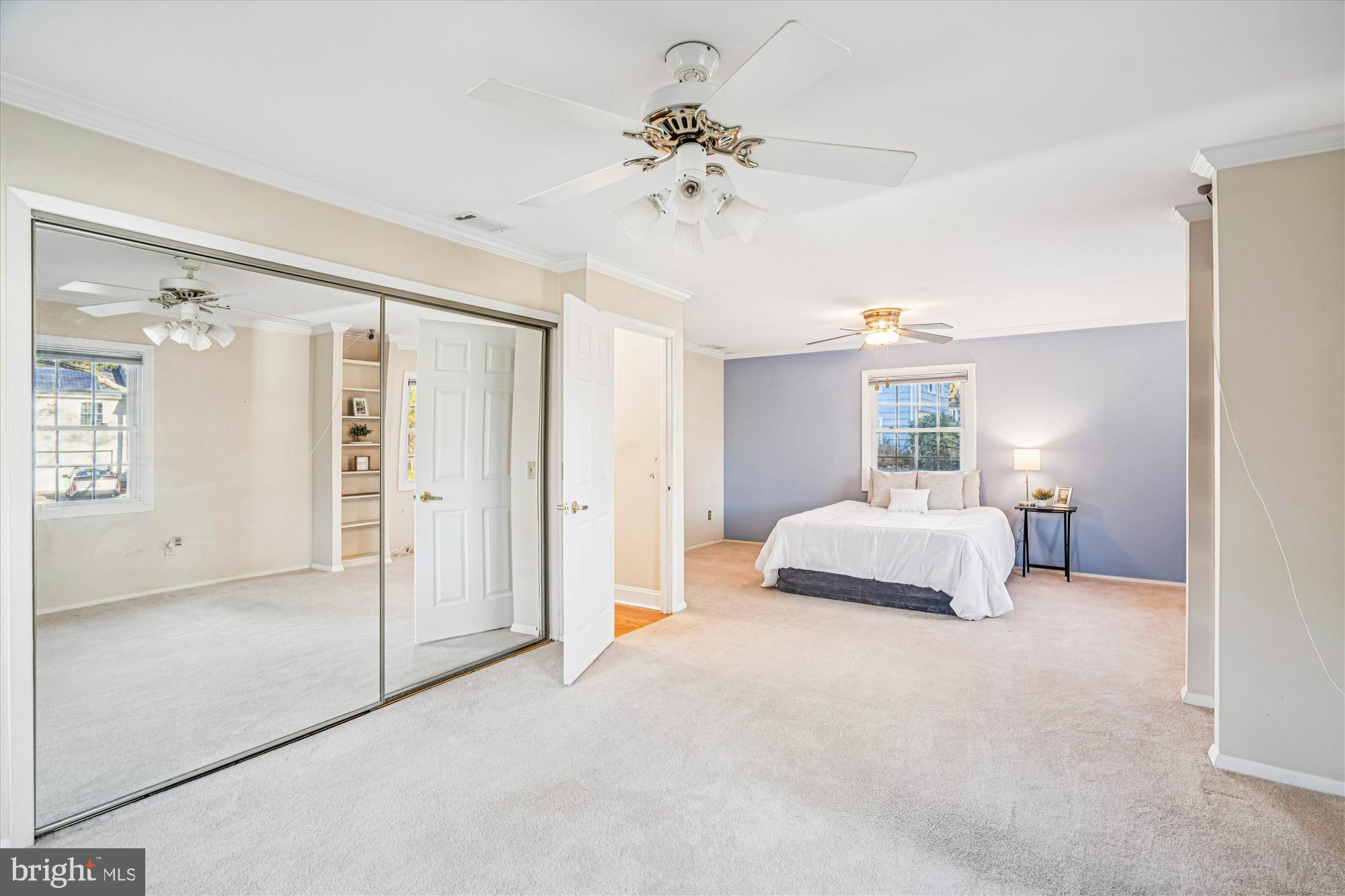 5134 West Running Brook Road Columbia, MD 21044 - Photo 47 of 99 a spacious bedroom with a bed and a chandelier