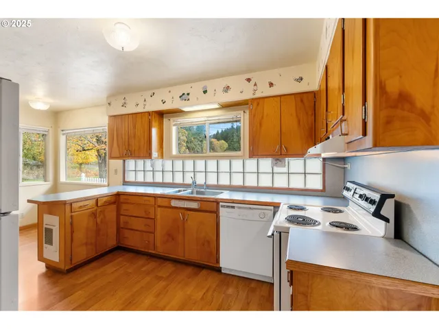 a kitchen with stainless steel appliances granite countertop a stove and a sink