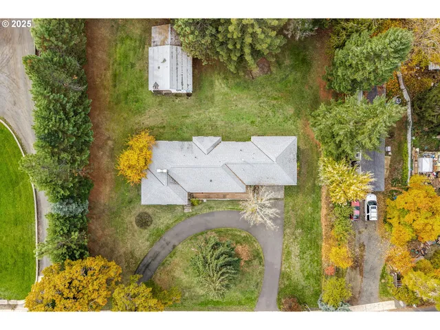 a aerial view of residential house with outdoor space and swimming pool