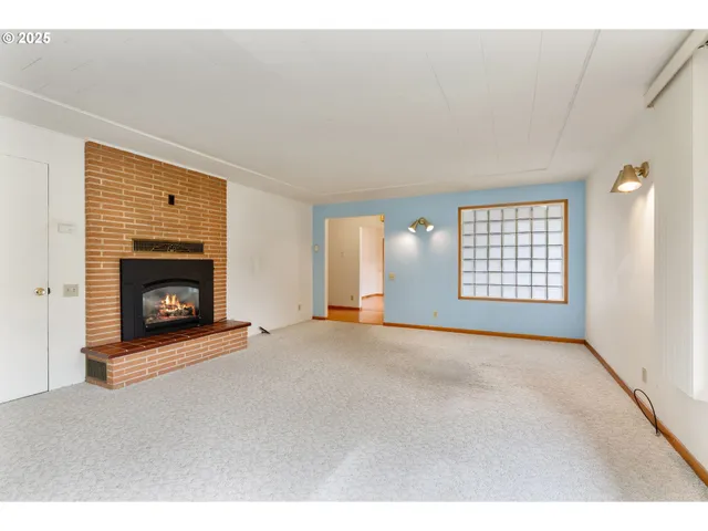 a view of living room with furniture and a fireplace