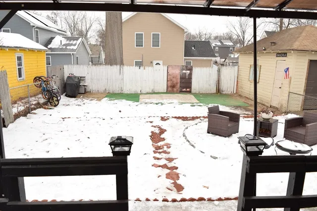 a view of a house with snow on the road