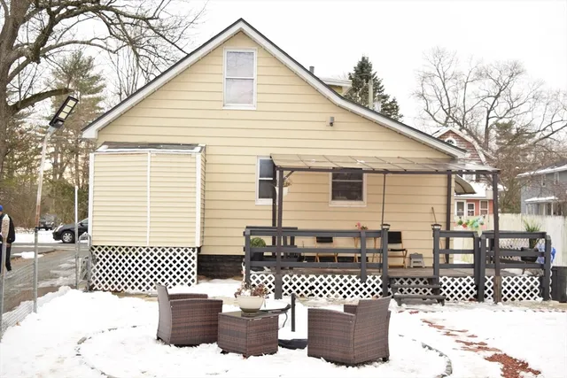 a view of a house with wooden fence