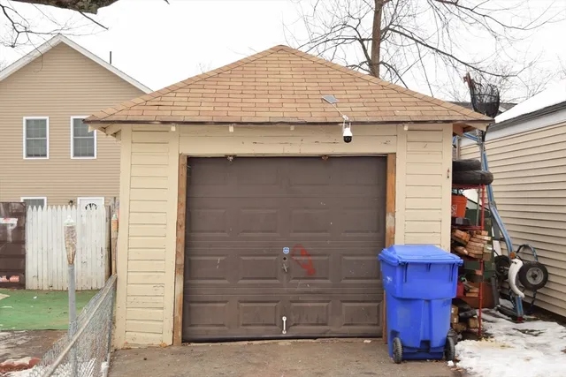 a view of a house with a small yard and wooden fence