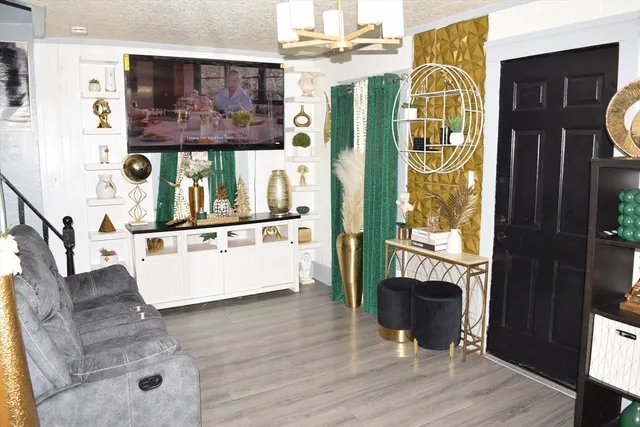 a living room with fireplace furniture and a window