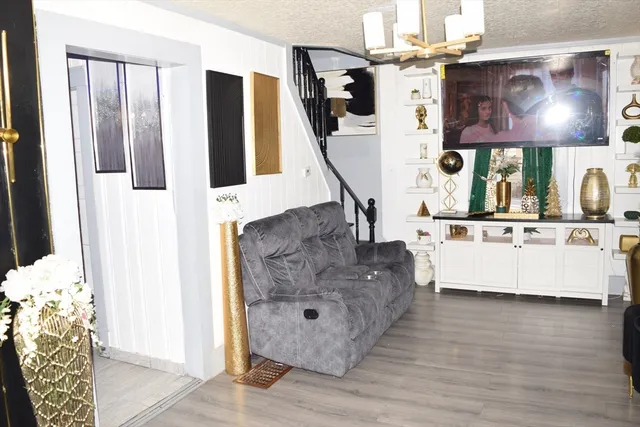 a dining room with furniture and wooden floor