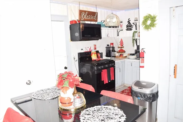 a kitchen with stainless steel appliances granite countertop a stove and cabinets