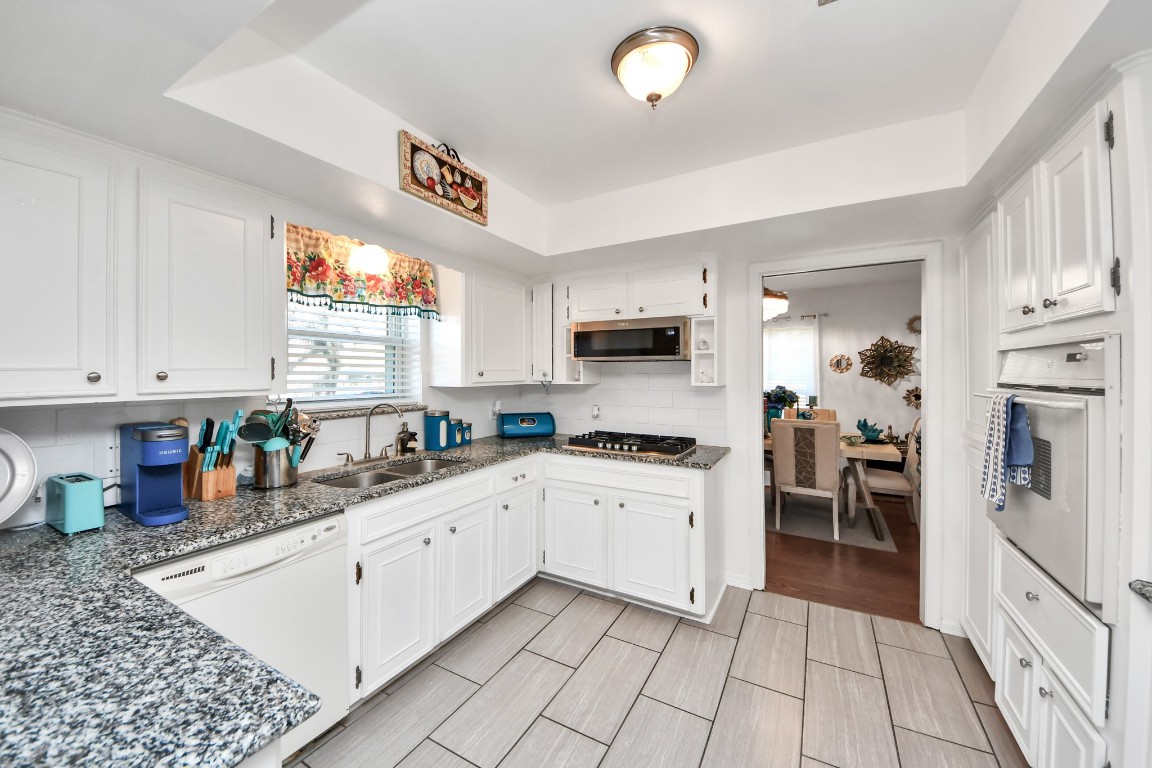 1805 9th Street Hempstead, TX 77445 - Photo 14 of 35 a kitchen that has a lot of cabinets in it and appliances