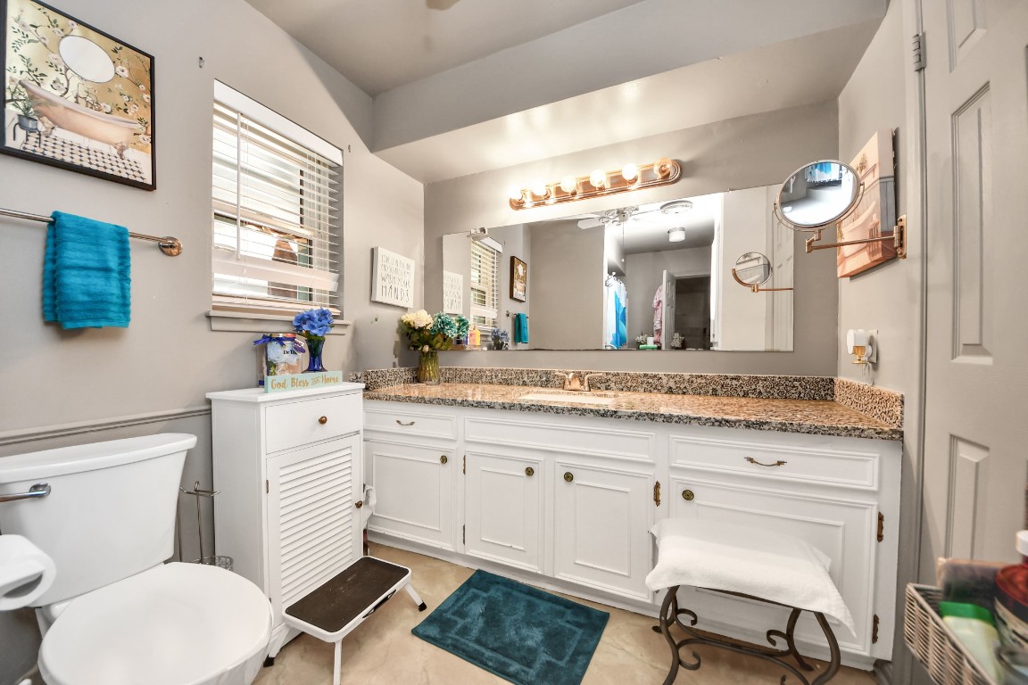 1805 9th Street Hempstead, TX 77445 - Photo 22 of 35 a bathroom with a granite countertop toilet sink and mirror