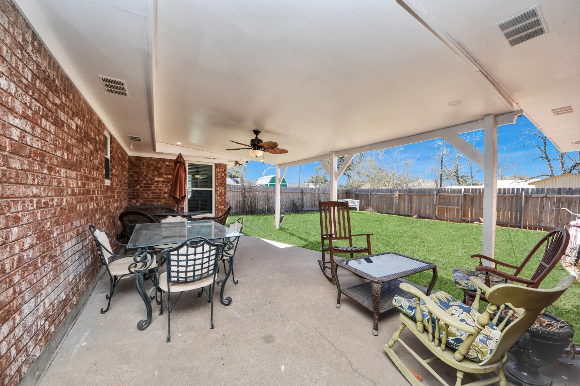 1805 9th Street Hempstead, TX 77445 - Photo 26 of 35 a view of a patio with a table chairs and a small yard