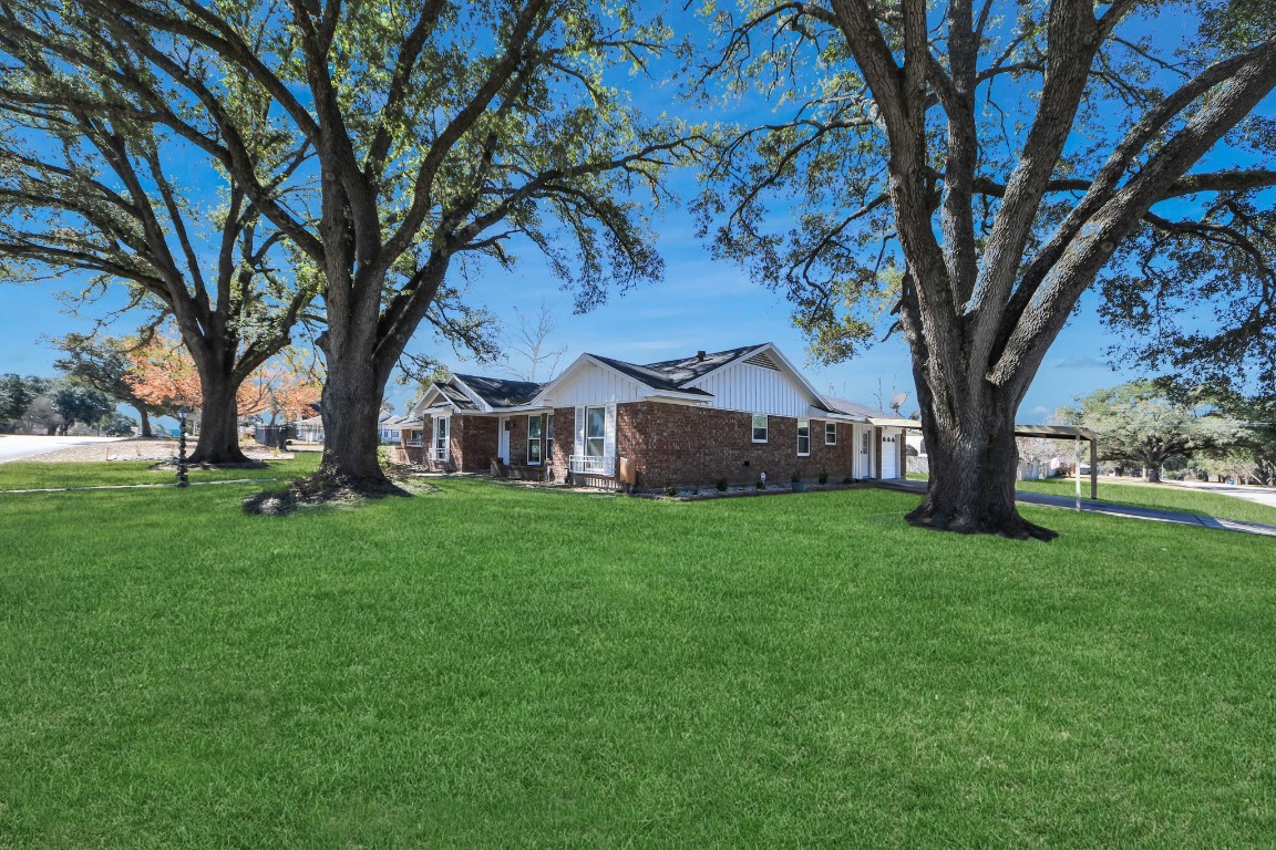 1805 9th Street Hempstead, TX 77445 - Photo 28 of 35 a view of a large garden with plants and large trees