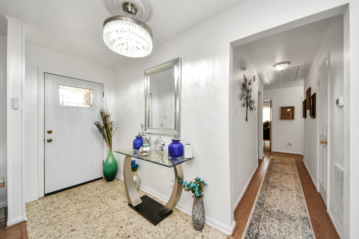 1805 9th Street Hempstead, TX 77445 - Photo 4 of 35 a view of a hallway to a livingroom and a dining room with furniture and wooden floor
