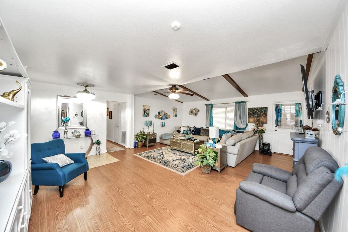 1805 9th Street Hempstead, TX 77445 - Photo 7 of 35 a living room with furniture and a chandelier