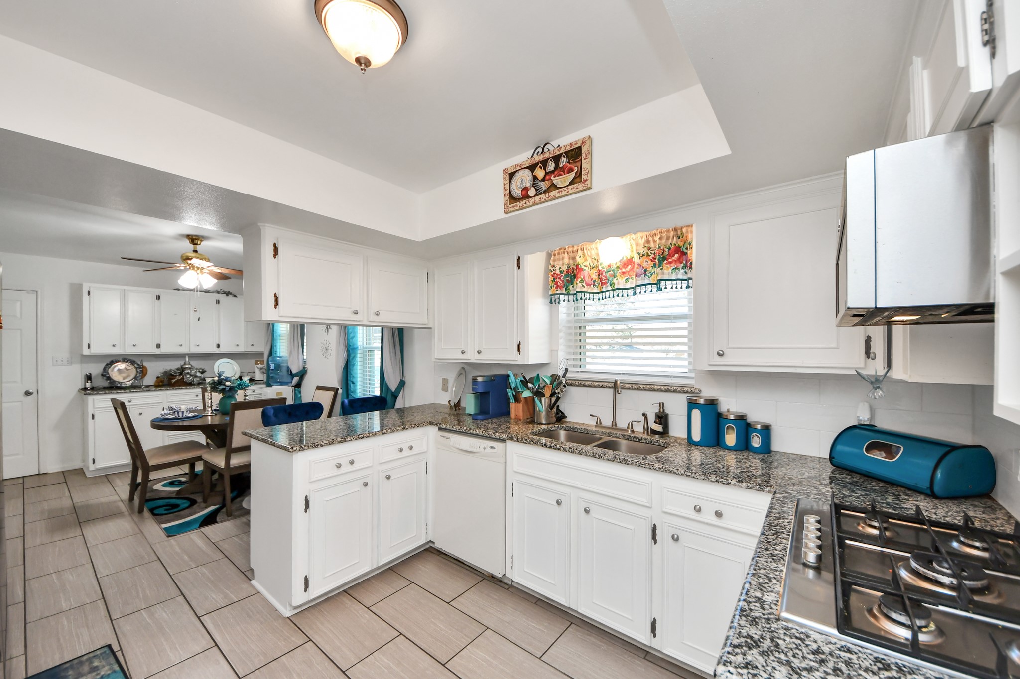 1805 9th Street Hempstead, TX 77445 - Photo 10 of 35 a kitchen with stainless steel appliances a stove a sink a refrigerator cabinets and dining table