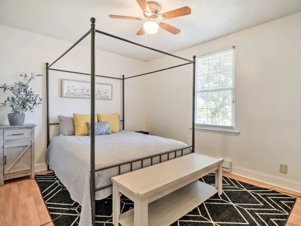 a bedroom with a bed and a window