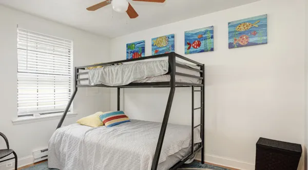 a bedroom with a bed and a window