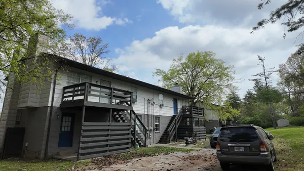 a front view of a house with parking space