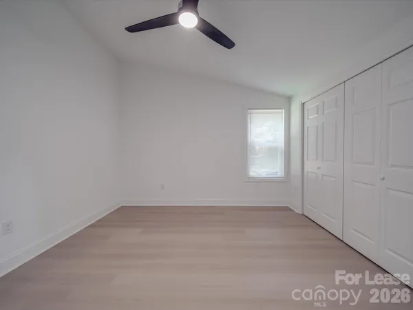 an empty room with a empty space and windows