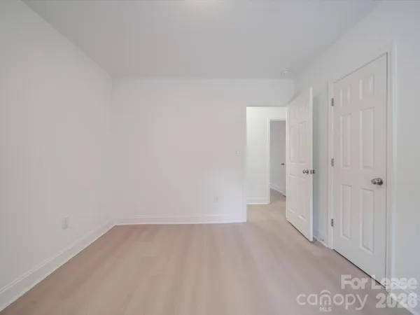 a view of a room with wooden floor and white doors