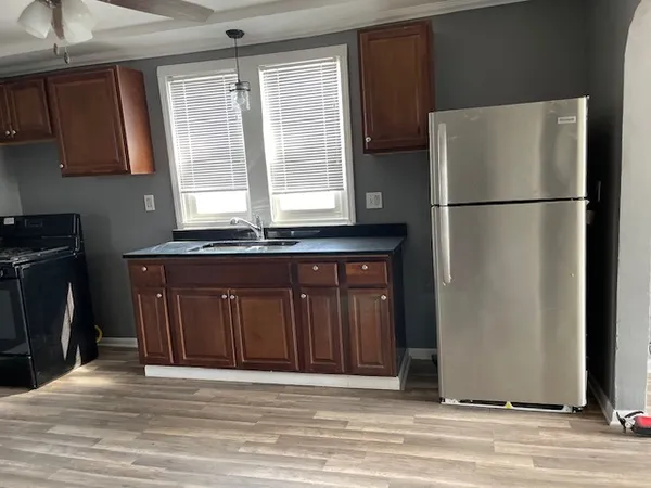 a kitchen with stainless steel appliances granite countertop a refrigerator stove and sink