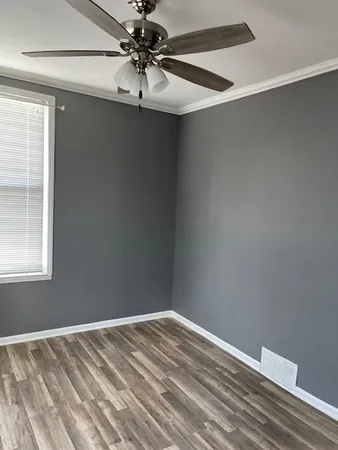 a view of a room with a fan and a window