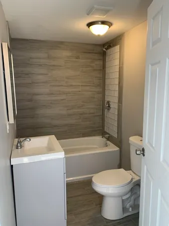 a bathroom with a sink a toilet and bathtub