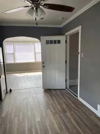 a view of empty room with wooden floor