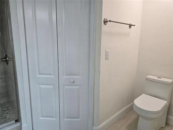a bathroom with a toilet and a shower