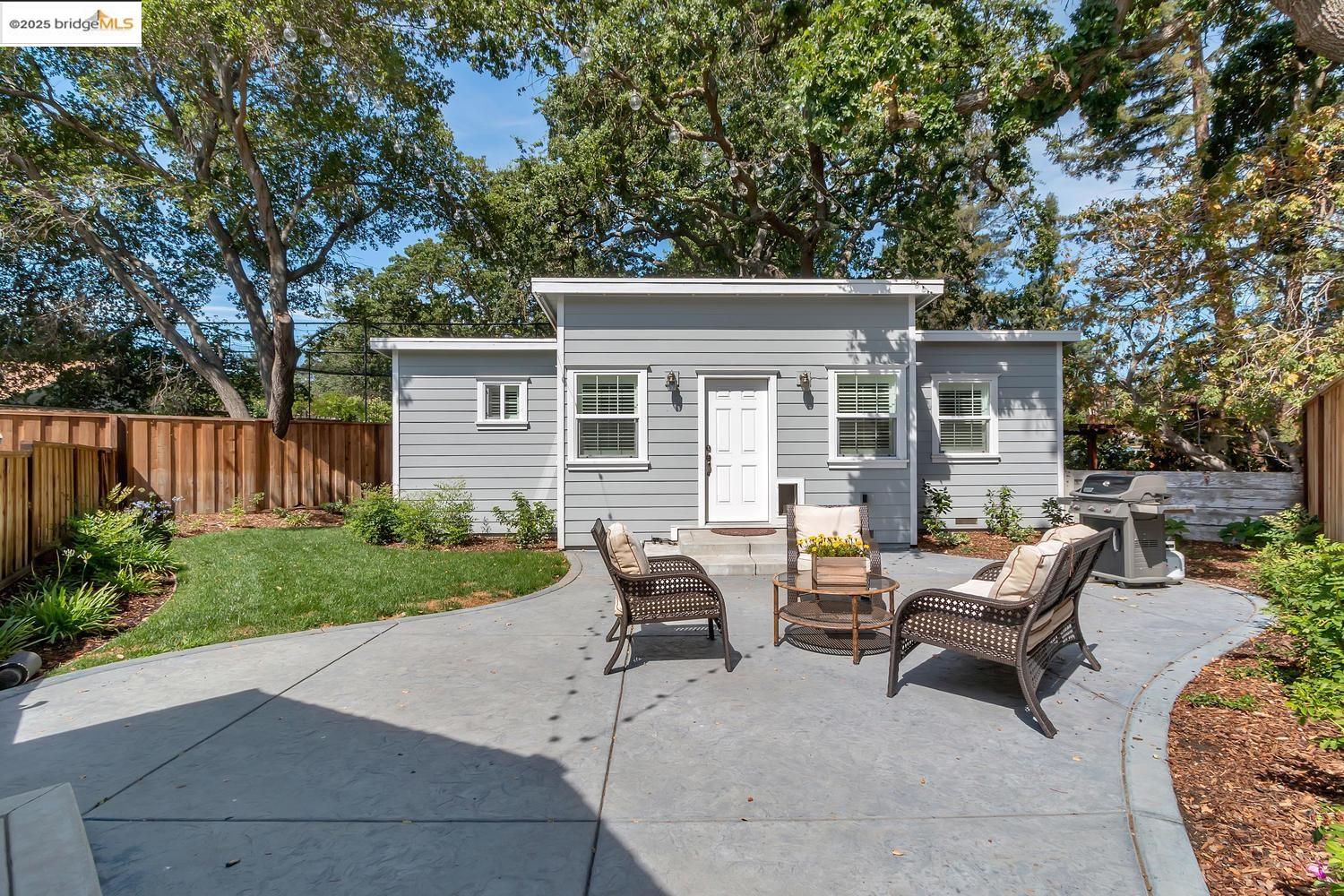 a view of backyard with outdoor seating and green space