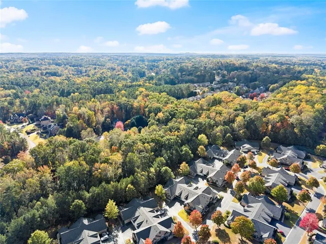 a view of a livingroom with wooden floor and a fireplace