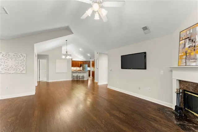 a view of a dining room with furniture a chandelier and wooden floor