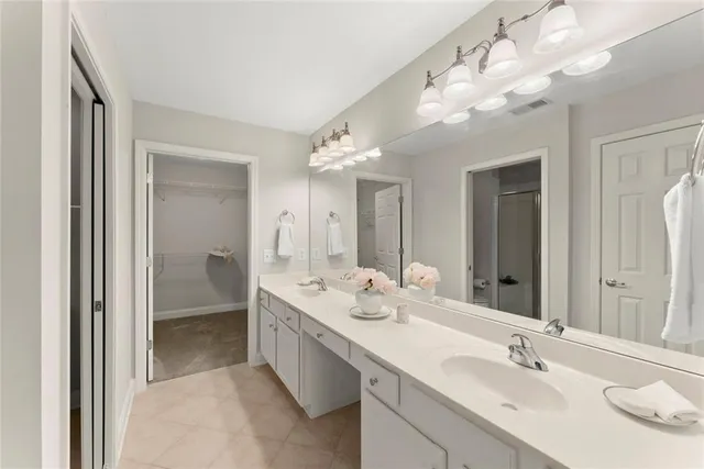 a view of an empty room with a chandelier fan