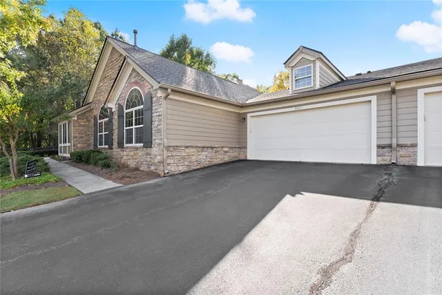 a view of a white house with a street