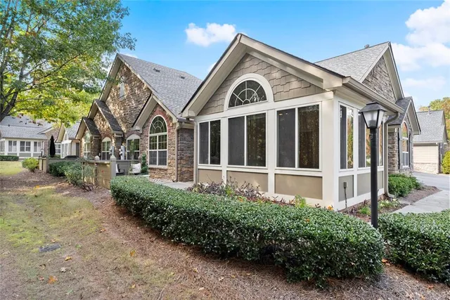 a front view of a house with a garden