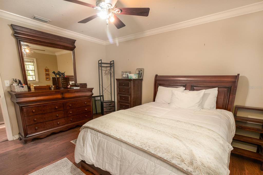 560 North Lake Pleasant Road Apopka, FL 32712 - Photo 11 of 85 a bedroom with a bed and a dresser