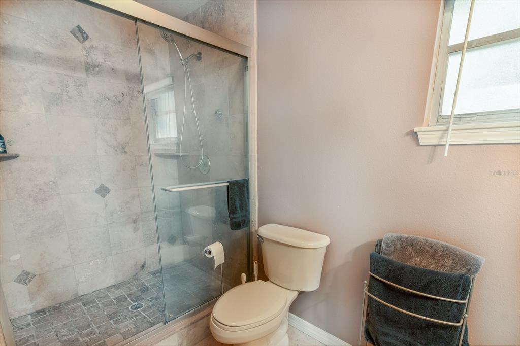 560 North Lake Pleasant Road Apopka, FL 32712 - Photo 13 of 85 a white toilet sitting next to a shower