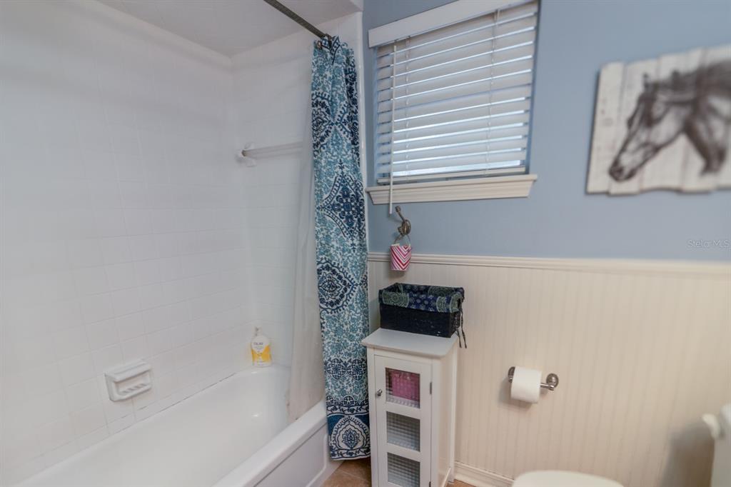 560 North Lake Pleasant Road Apopka, FL 32712 - Photo 19 of 85 a bathroom with a bathtub and a shower