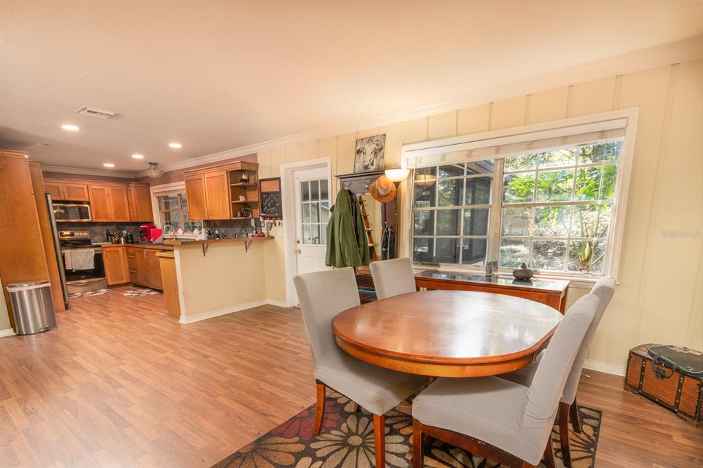 560 North Lake Pleasant Road Apopka, FL 32712 - Photo 2 of 85 a view of kitchen and dining room with wooden floor