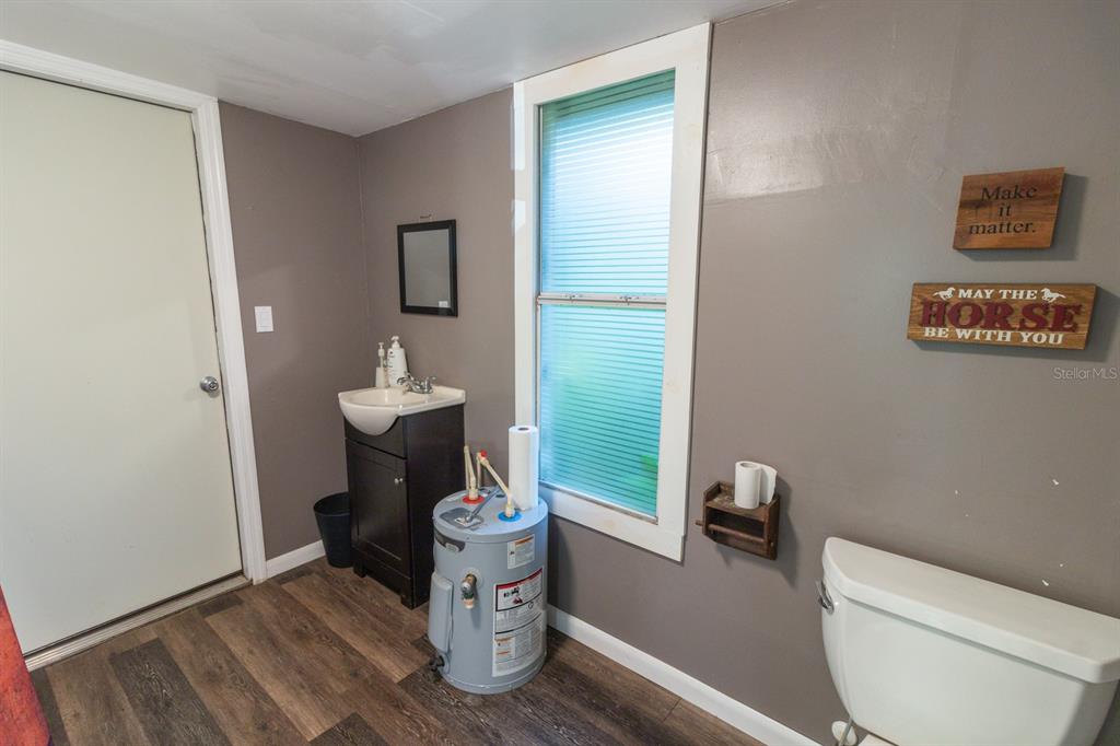 560 North Lake Pleasant Road Apopka, FL 32712 - Photo 25 of 85 a bathroom with a toilet and a sink